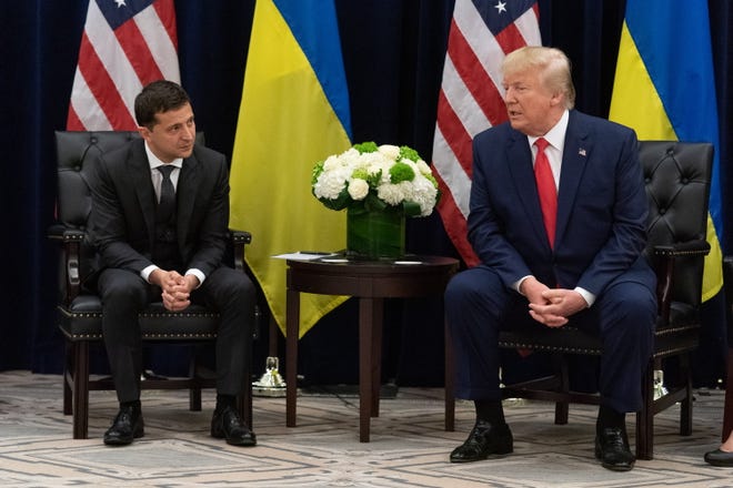 Former President Donald Trump, seen here in 2019 with Ukrainian President Volodymyr Zelensky, has said Russia's attack of Ukraine would not have happened had he been in the Oval Office and that he would broker a peace agreement if he returns to the White House.