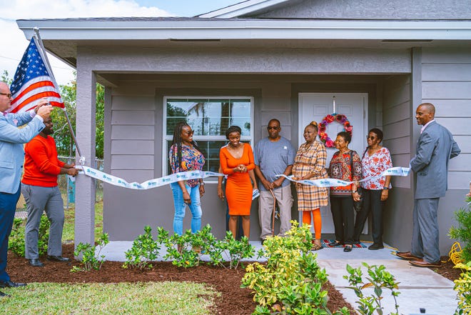 Kendra Wilson receives the keys to her new home from Habitat for Humanity of Greater Palm Beach County on Friday, Feb. 16, 2023. The home is on Northwest 11th Avenue in Boynton Beach. Wilson is a mother of three who grew up in Delray Beach and works as a  phlebotomist.
