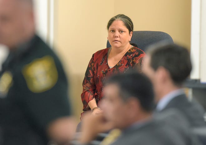 Christine Fenton Gilbert, of Fort Pierce, sits in a holding room after being sentenced by Circuit Judge William Roby in the Martin County Courthouse in Stuart for charges related to altering more than a dozen scratch-off Florida Lottery tickets, including one worth $20,000 that she admitted buying because she knew it was a winner. Judge Roby sentenced Fenton-Gilbert to 18 months in prison, followed by 13 years of probation after being released from prison, and ordered Fenton-Gilbert to pay $20,000 in restitution to the Florida Lottery and $1,196 to the Rebel Store in Jensen Beach, where she worked.