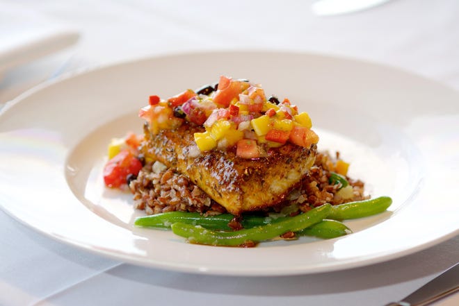 Yellow Dog Cafe in Malabar is known for seafood dishes like this blackened mahi which sometimes is offered as a special.