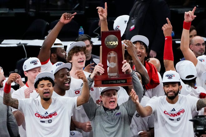 Mar 25, 2023; New York, NY, USA; Florida Atlantic Owls head coach Dusty May hoists the East Regional Champion trophy following their 79-76 victory against the Kansas State Wildcats in an NCAA tournament East Regional final at Madison Square Garden. Mandatory Credit: Robert Deutsch-USA TODAY Sports
