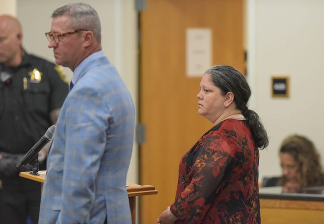 Christine Fenton Gilbert (right), of Fort Pierce, stands before Circuit Judge William Roby with her attorney, Michael Ohle, while being sentenced in the Martin County Courthouse in Stuart for charges related to altering more than a dozen scratch-off Florida Lottery tickets, including one worth $20,000 that she admitted buying because she knew it was a winner. Judge Roby sentenced Fenton-Gilbert to 18 months in prison, followed by 13 years of probation after being released from prison, and ordered Fenton-Gilbert to pay $20,000 in restitution to the Florida Lottery and $1,196 to the Rebel Store in Jensen Beach, where she worked.