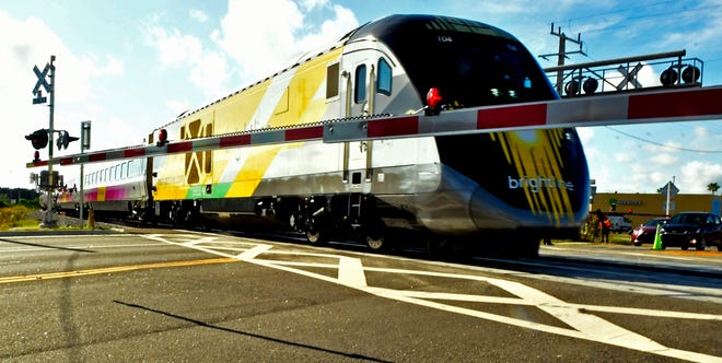 A Brightline train crosses Dixon Boulevard in November in Cocoa during the early hours of an up-to-79 mph testing period across the Cocoa-Rockledge area.