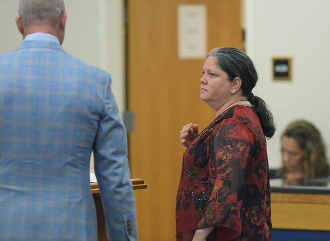 Christine Fenton Gilbert (right), of Fort Pierce, stands with her attorney  Michael Ohle before being sentenced by Circuit Judge William Roby in the Martin County Courthouse in Stuart for charges related to altering more than a dozen scratch-off Florida Lottery tickets, including one worth $20,000 that she admitted buying because she knew it was a winner. Judge Roby sentenced Fenton-Gilbert to 18 months in prison, followed by 13 years of probation after being released from prison, and ordered Fenton-Gilbert to pay $20,000 in restitution to the Florida Lottery and $1,196 to the Rebel Store in Jensen Beach, where she worked.