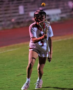 Vero Beach's Kerrigan Gilmore controls the ball during a high school lacrosse game against Jensen Beach on Monday, Feb. 27, 2023 in Vero Beach. Vero Beach won 13-10.