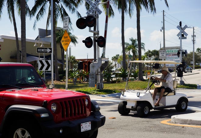 A golf cart navigates through the Jensen Beach Boulevard roundabout, Friday, Feb. 24, 2023. A crackdown has begun by the Martin County Sheriff's Office on golf cart owners who are driving on public roads without the proper registration and safety equipment such as mirrors, tail lights and seatbelts. The countywide issue notably has been seen in Jensen Beach, Palm City and Port Salerno.