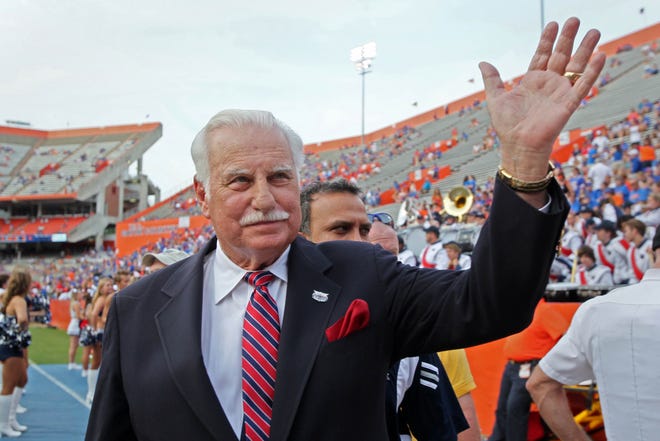 FAU Owls head coach Howard Schnellenberger waves to the crowd during before FAU's game at Florida in 2011. Schnellenberger died in 2021.
