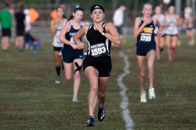 "I felt like I did pretty well. I tried to pass as many people as I could to try to help my team get to regionals and we ended up doing that," said John Carroll's Grace Reed (center), 16, who finished third in the girls District 4-1A cross country championships on Saturday, Oct. 30, 2021, at the Indian River County Fairgrounds in Vero Beach. Reed had a time of 20:05.7.