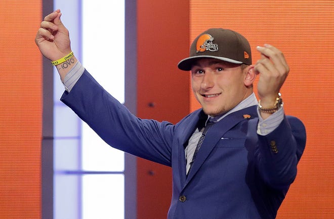Johnny Manziel flashes his money gesture after being selected by the Cleveland Browns with the 22nd pick in the 2014 NFL draft.