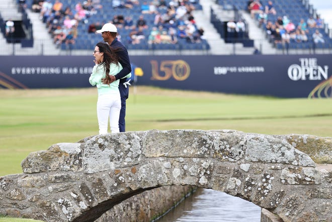 JULY 12, 2022 -- Tiger Woods looks on alongside Partner Erica Herman during a practice round prior to The 150th Open Championship at St Andrews Old Course.