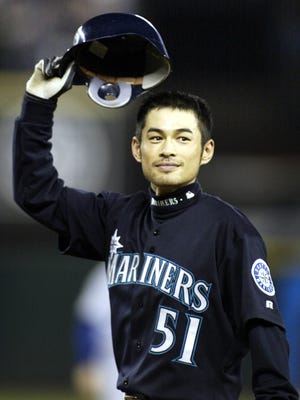 Ichiro Suzuki tips his hat to the fans after breaking the single-season hit record in 2004.