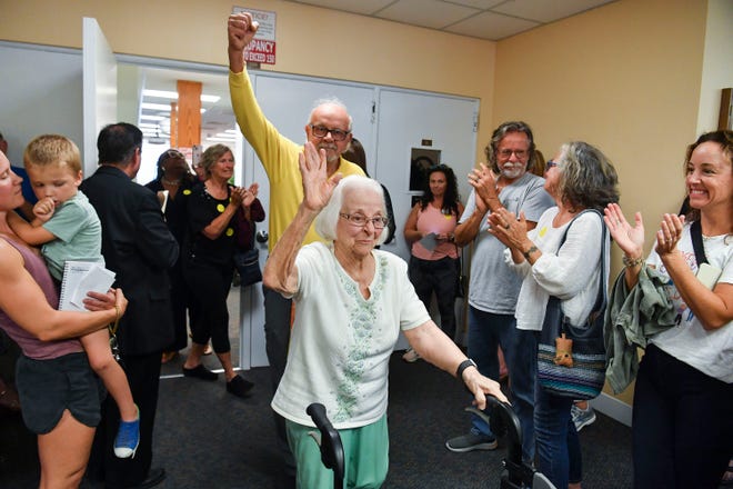 Grace Linn, 100, of Jensen Beach, waves to an applauding crowd after she spoke about the 80 books that were removed last month from district school media centers during the Martin County School Board meeting, Tuesday, March 21, 2023, at 500 SE Ocean Blvd in Stuart. "My husband, Robert Nicoll, was killed in action in World War II, at a young age, defending our democracy, Constitution and freedoms," said Linn. "One of the freedoms the Nazis crushed was the freedom to read the books they banned. They stopped the free press, banned and burned books. The freedom to read, which is protected by the First Amendment is our essential right and duty of our democracy. Even so, it is continually under attack by both public and private groups who think they hold the truth." Pulitzer Prize winner Toni Morrison and best-selling young-adult novelist Jodi Picoult are some of the writers whose works were removed from the Martin County School District's middle and high schools last month.