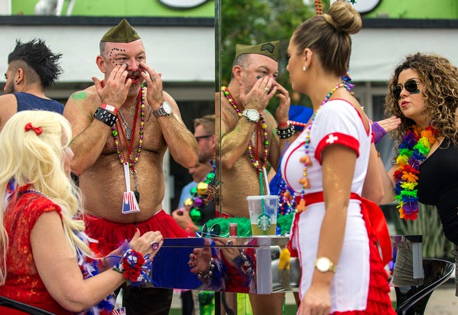 Justin Jordan, (2L), applies black eye and other final touches along with Lisa De Marinis, (R), Erin Rafus, (2R), and Christina Borchers, (R), on the J&G The Beauty Loft float before the start of the Seventeenth Annual Pride Fest of the Palm Beaches parade Sunday March 20, 2016, through downtown Lake Worth. Over 500 people, and close to fifty floats paraded by large crowds that lined Lake Avenue for the conclusion of the two day event.