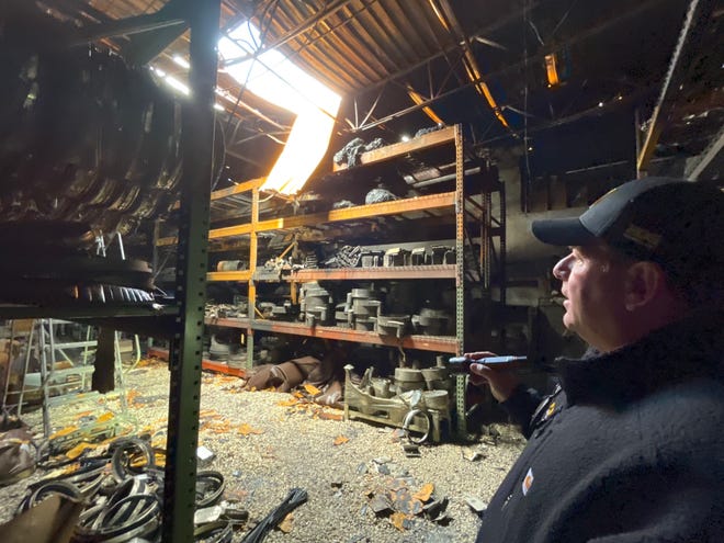 HOG Technologies CEO James Crocker walks through the building where a fire erupted March 17, 2023.