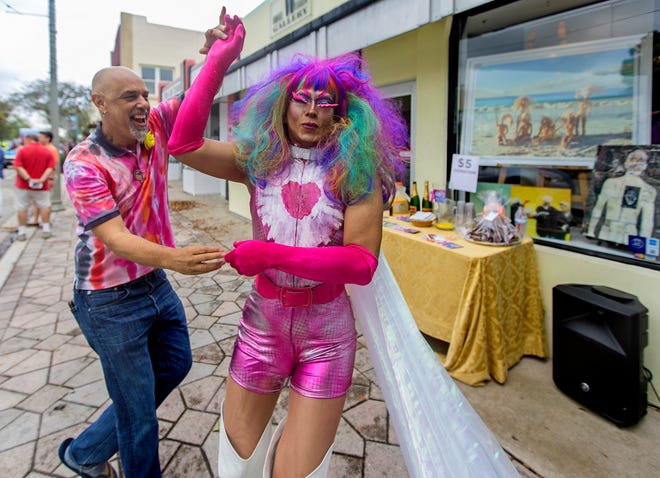 Akrylika,(R), dances with gallery owner Rolando Chang Barreto, (L), on Lucerne avenue before the start of the seventeenth Annual Pride Fest of the Palm Beaches parade Sunday March 20, 2016, through downtown Lake Worth.Over 500 people, and close to fifty floats paraded by large crowds that lined Lake Avenue for the conclusion of the two day event.