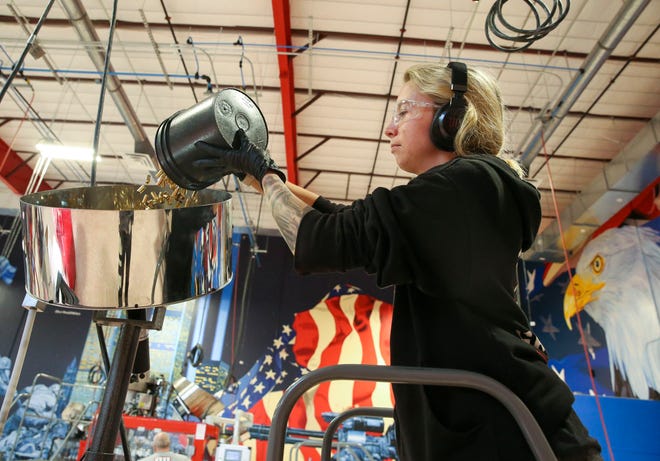 Grind Hard Ammo employee Mary Strunk adds casings to a machine that puts the primer insertion into the casing, Thursday, Feb. 23, 2023, at the Willoughby Business Park in Stuart. Grind Hard Ammo manufactures copper shell casings at the Stuart facility and plans to build a facility in Indiantown, where they would make primers, or the explosive substance that energizes the powder in the case of each shell. The company primarily sells ammunition to law enforcement and the military. Its website sells consumer ammunition and merchandise such as T-shirts and hats. The facility is not open to the public.