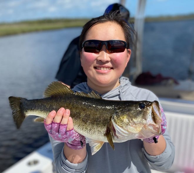 Haydyn Fay with the largemouth bass she caught in the Tomoka River, aboard Capt. Jeff Patterson's Pole Dancer.
