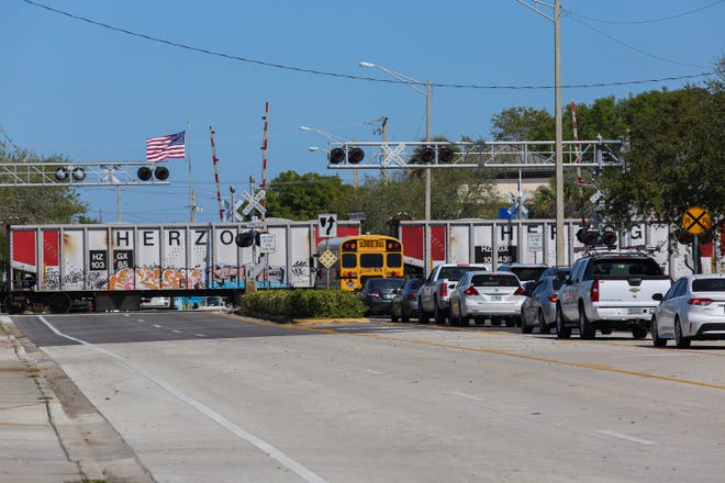 Traffic backs up on 16th Street headed east as a train slowly moves through Vero Beach on Thursday, March 2, 2023. The track’s crossing gates remained in the upright position as it passed through parts of the county.