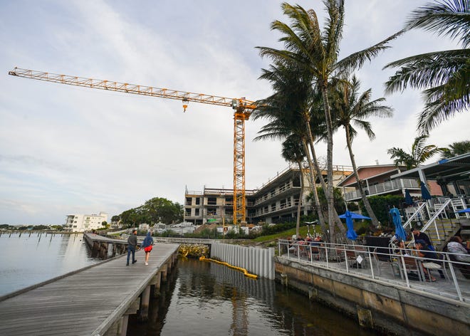 A tower crane is seen in downtown Stuart on Thursday, March 24, 2022. The crane has been a downtown fixture for nearly a year and is being used in the construction of a four-story condominium. The building's roofing and walls on the final level are expected to be complete in about a month.