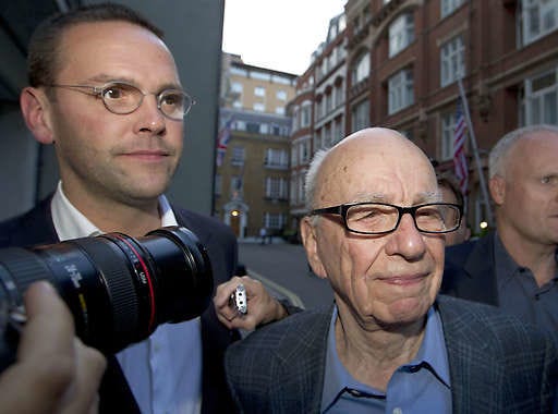 Rupert Murdoch, right, and his son James Murdoch arrive at his residence in central London in this July 2011 photo. Sang Tan | Associated Press