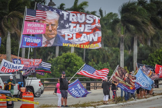 Supporters of former President Donald Trump congregate just west of Mar-a-Lago on Southern Boulevard in Palm Beach on Sunday, March 19, 2023.
