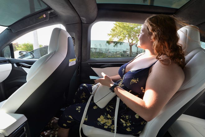Kristin Wilson catches a view of Seaway Drive using the Freebee Tesla to ride from Colonnades Drive to downtown Fort Pierce, on Friday March 3, 2023.