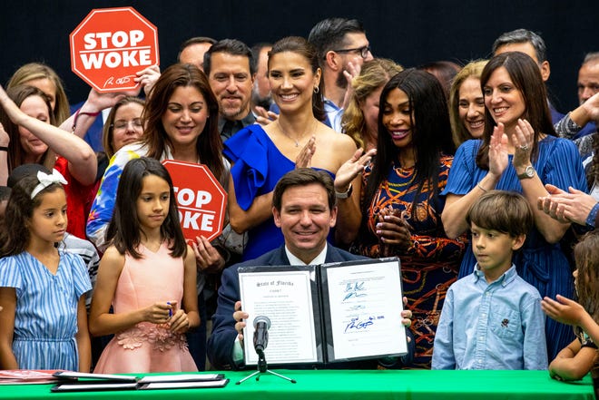 Florida Gov. Ron DeSantis signs the Stop WOKE Act in April 2022.