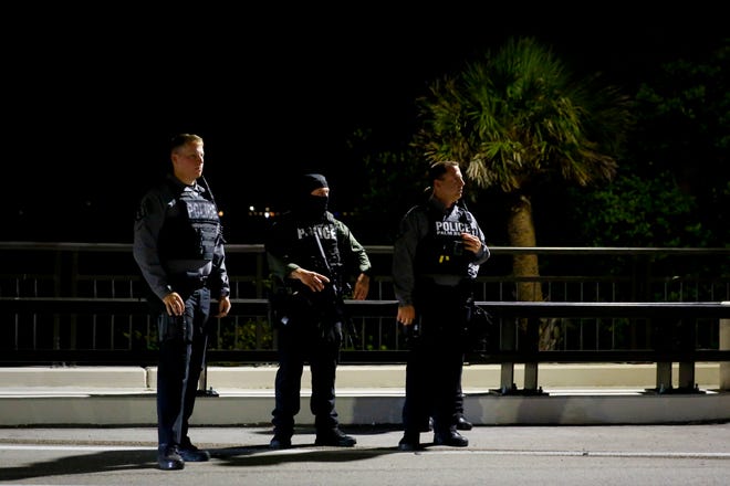 Police officers keep watch near the home of former President Donald Trump at Mar-A-Lago on Aug. 8, 2022, in Palm Beach.