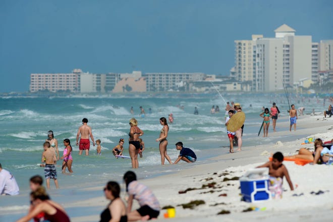 Swimmers enjoy the Gulf of Mexico at Henderson Beach State Park in Destin