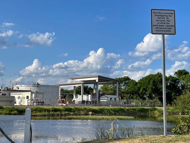 A sign saying Titusville is investigating a fish kill at a pond adjacent to the city's Osprey sewage treatment plant.