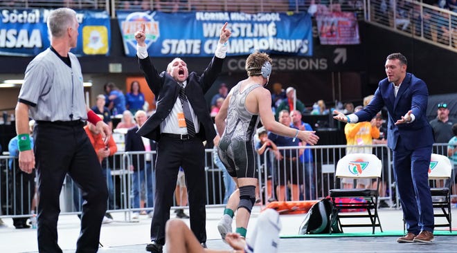 Jensen Beach head coach Tom McMath celebrates Dylan Fox's state title victory at 152 pounds that secured the 1A championship at the FHSAA Championships held at Silver Spurs Arena on Saturday, Mar. 4, 2023 in Kissimmee.