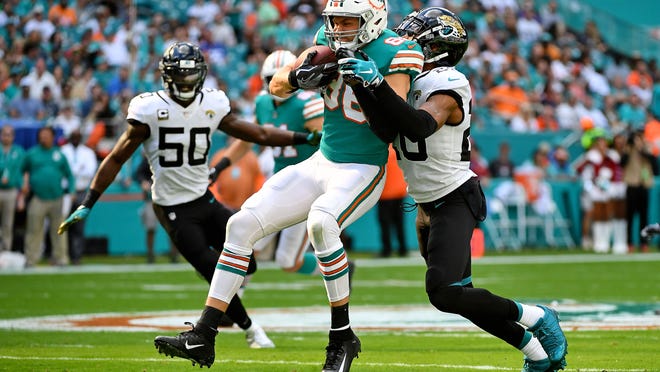 Jalen Ramsey, then with the Jaguars, tackles Dolphins tight end Mike Gesicki during a game at Hard Rock Stadium in 2018.