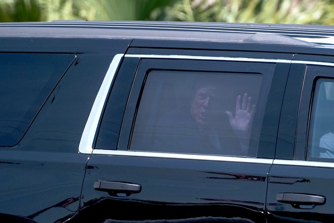 Former President Donald Trump waves to his supporters while riding in a motorcade to Palm Beach International Airport on Monday, April 3, 2023, in West Palm Beach, FL. Former President Trump departed Palm Beach County for New York, where he faces arraignment on Tuesday.