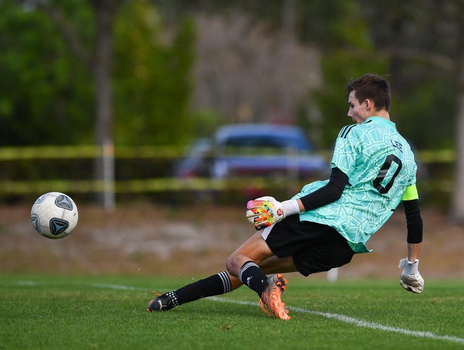 St. Edward's goalkeeper Alex Lee blocks a shot from Pine School in a District 8-2A championship match on Feb. 1 in Hobe Sound. The Pine School won 3-0.