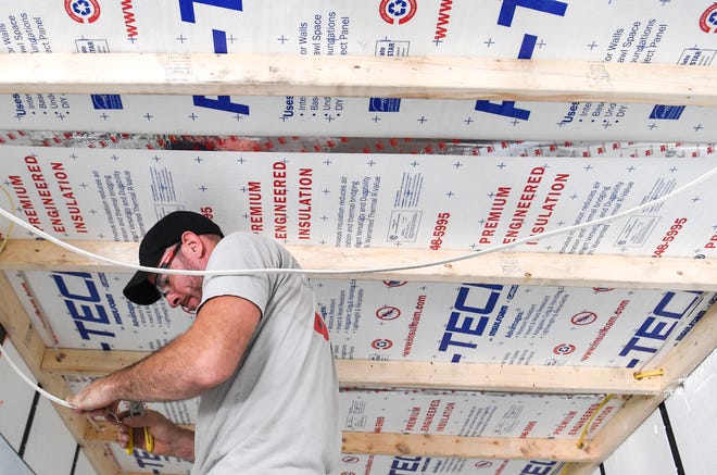 Containing Luxury employee William Bender, of Port St. Lucie, works on electrical wiring while building a 20-foot container home, Friday, March 17, 2023, at 4402 SW Port Way in Palm City.  The company converts steel shipping containers into tiny homes and is one of more than 100 businesses in the tri-county area that is a Second Chance employer, which seeks to hire some people looking for a fresh start after coming out of prison, participating in a diversion court program, or who are in recovery.