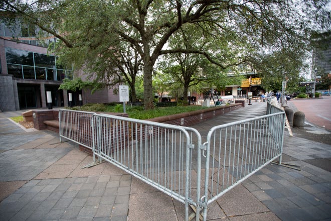 Metal barricades surround the public space outside the Tallahassee City Hall building following the arrests of several activists who were protesting SB 300 Monday evening.