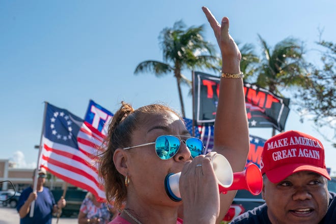 Mike Lindell, the My Pillow Inc chief executive and Trump supporter, greets Trump supporters as they wait along the motorcade route for former President Donald Trump to return home to Mar-a Lago following his arraignment in New York on April 4, 2023.