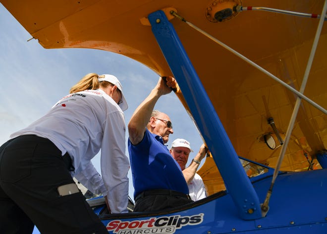 Pilot Darryl Smith (right) and crew chief Melanie Smith (left) help Korean War veteran James Hoshowsky, 89, into a 1940 Stearman biplane, Thursday, April 6, 2023, at Witham Field in Stuart. "The purpose of Dream Flights is to give back to those who gave, and you all are the ones who gave," said pilot Darryl. "It's our mission to give something back to you for what you've done for our country." Dream Flights gifted Hoshowsky and five other veterans a flight in the WWII-era plane.