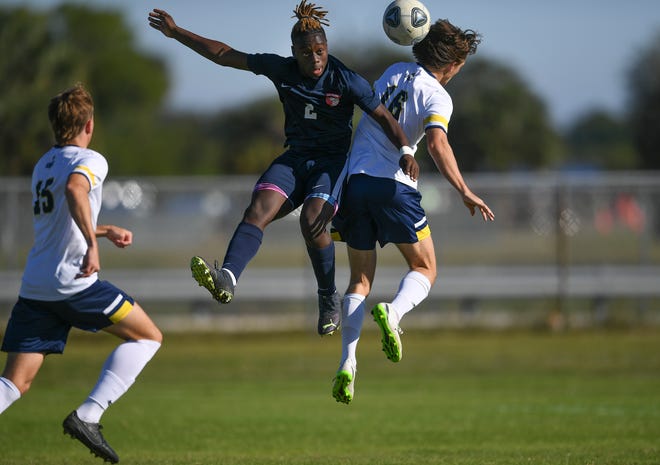 St. Lucie West Centennial's Kaelen Vilarson, center, and Pine School's Dylan Markulics, right, clash during the first half of their match at St. Lucie West Centennial High School on Jan. 11 in Port St. Lucie. The game ended in a 1-1 draw.