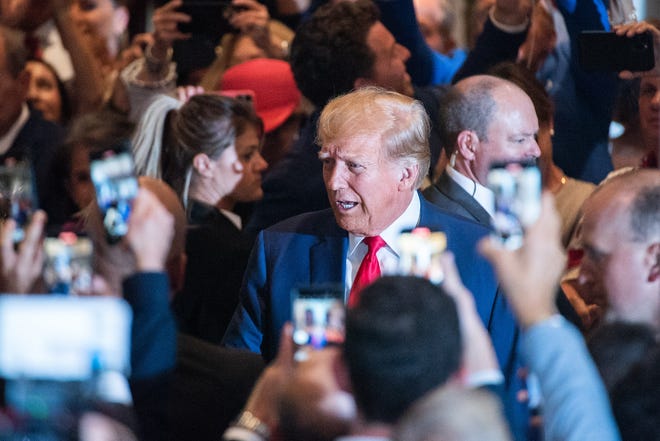 Former President Donald Trump greets supporters as he arrives at Mar-A-Lago on Tuesday, April 4, 2023, in Palm Beach.